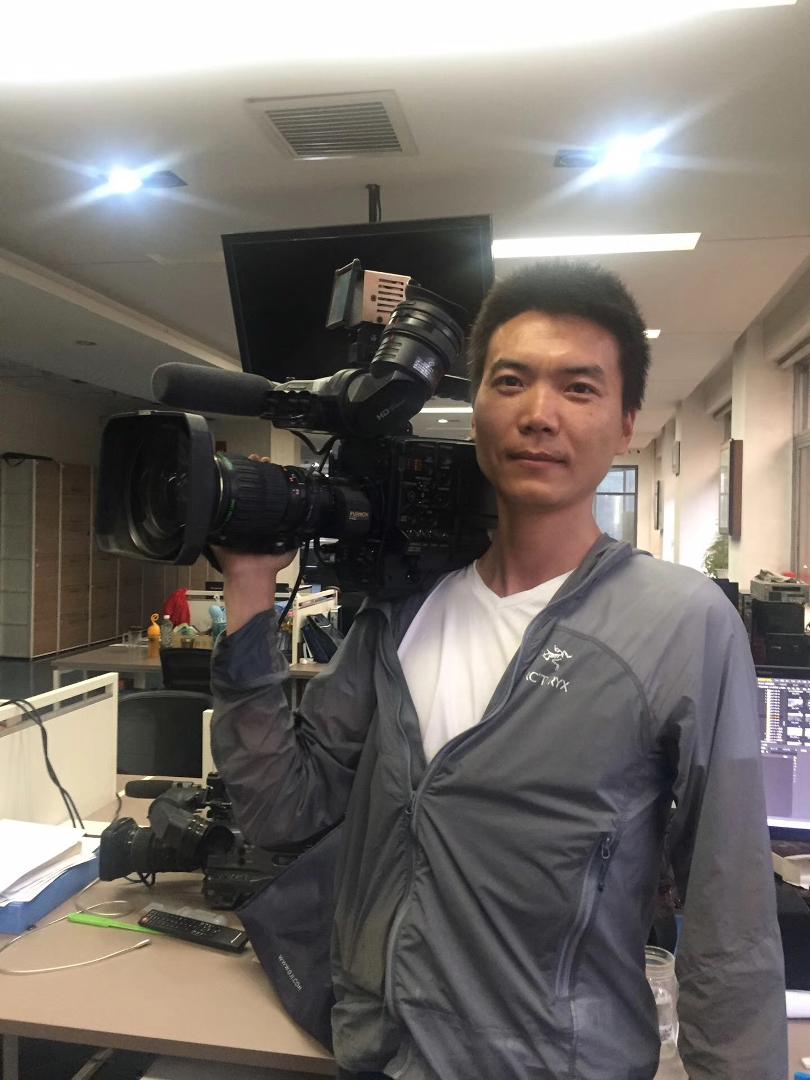 Working with a shoulder-mounted camera.